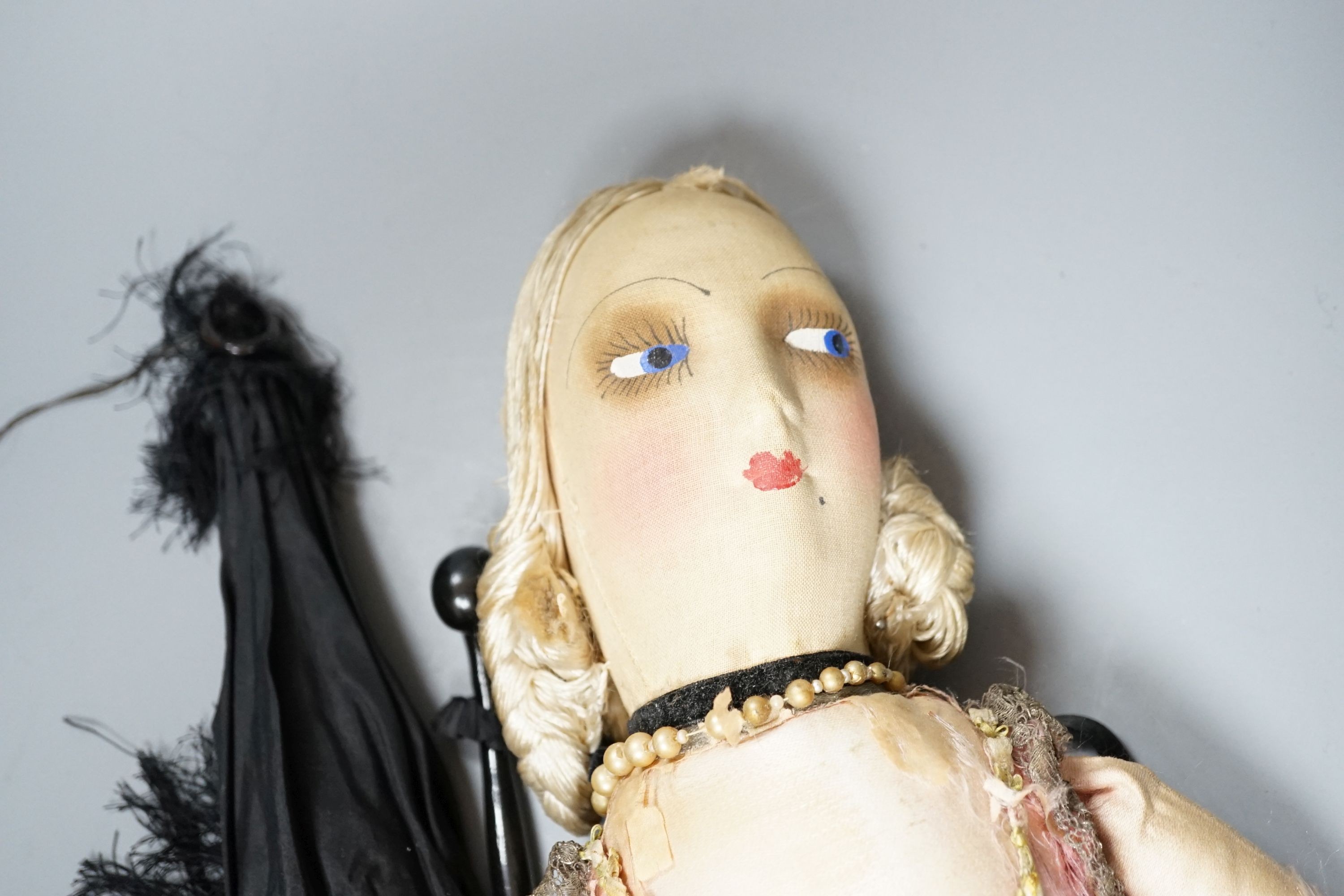 A boudoir doll circa 1920's and a black parasol